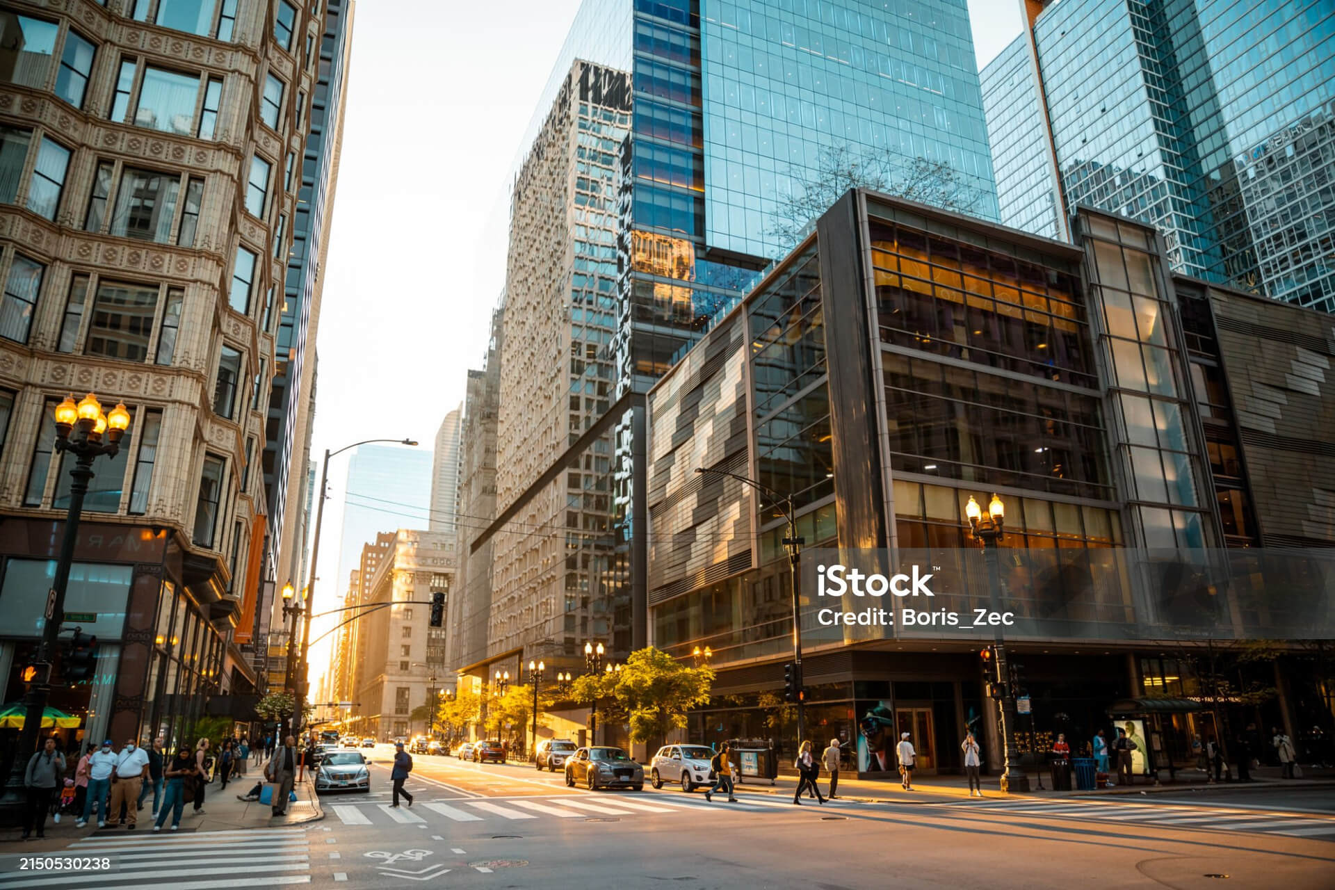 Buildings in a city with pedestrians walking by