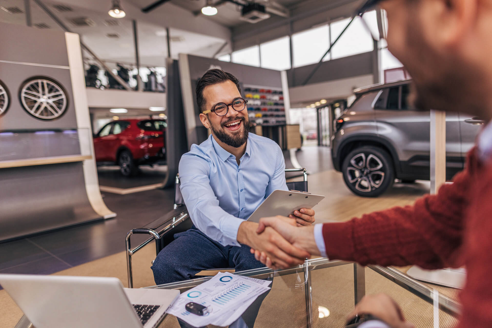 Man shaking hands with customer at dealership